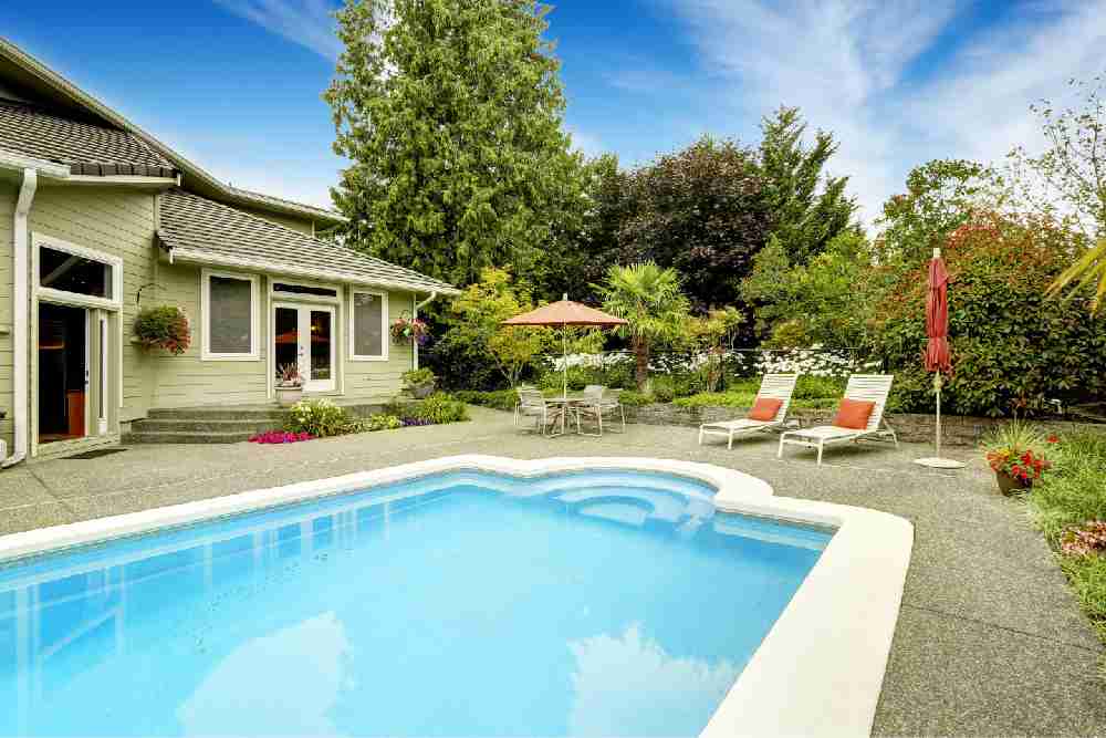 Dive into relaxation in a backyard pool, complemented by a picturesque pool patio and captivating focal point landscaping.